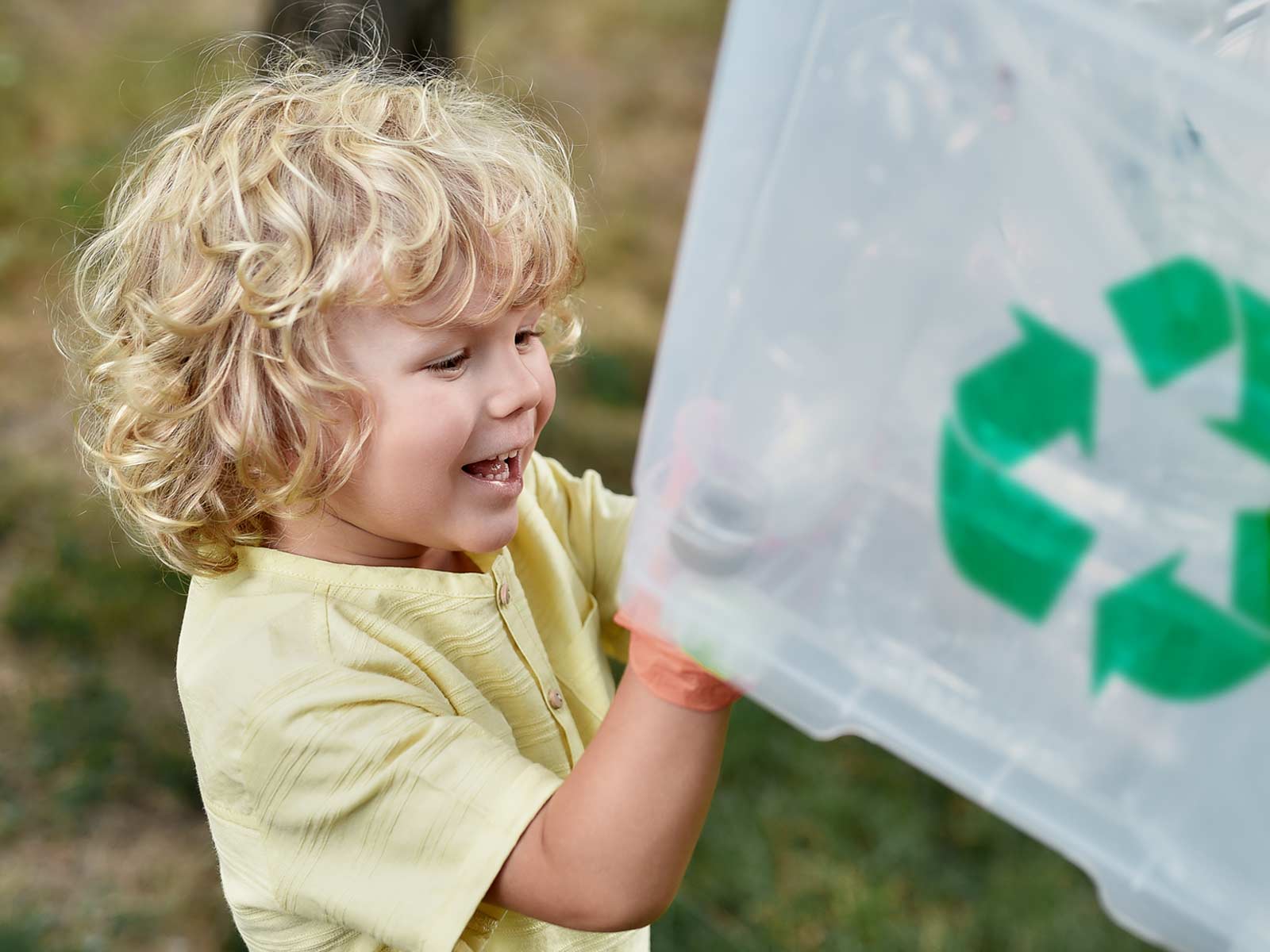 Happy child recycling