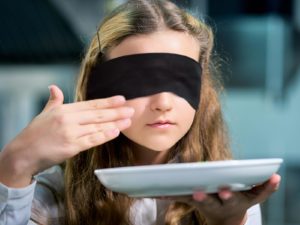 Girl blindfolded smell test