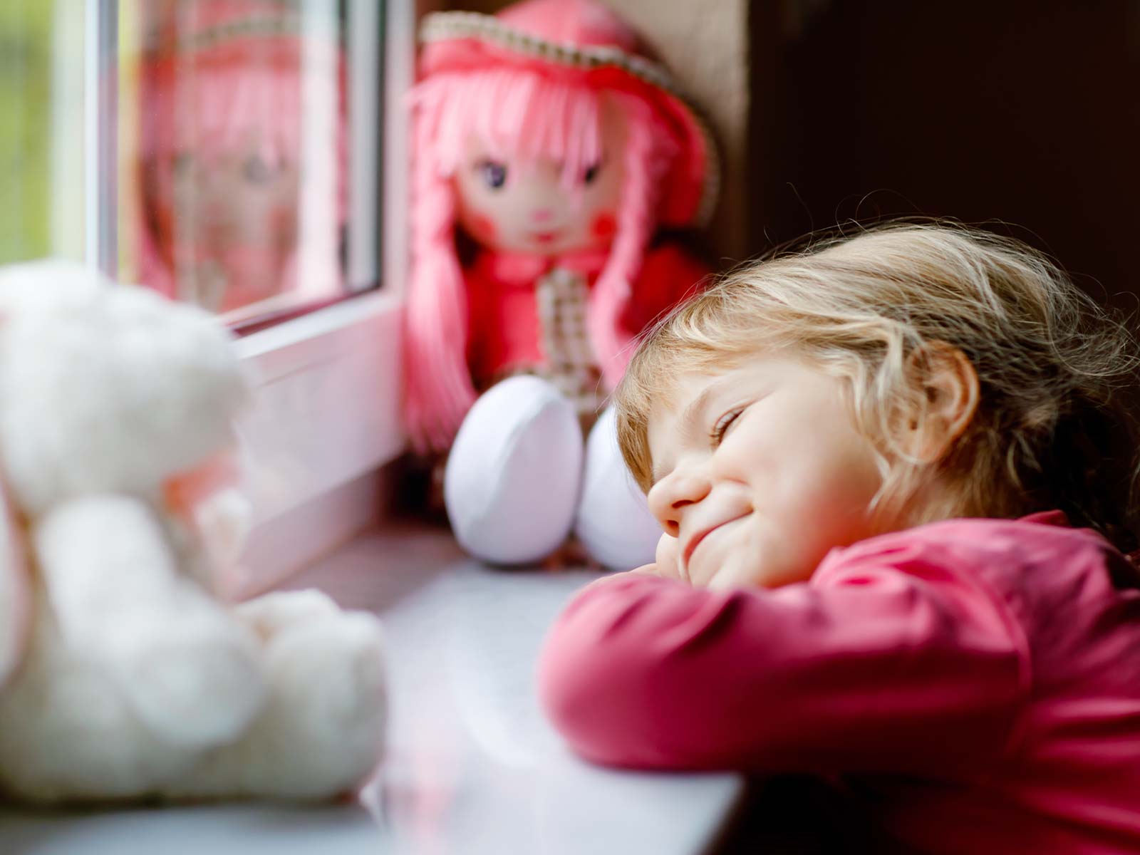 child daydreaming at window