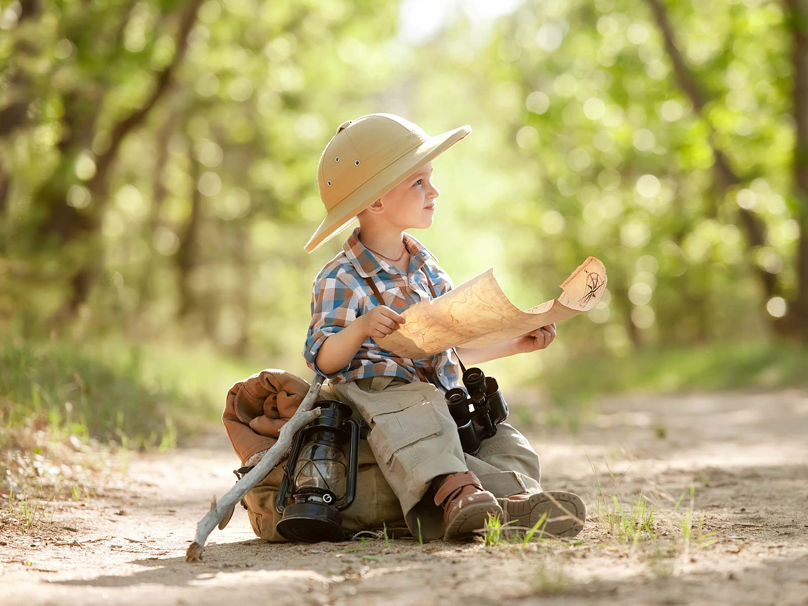 Boy reading a map while exploring