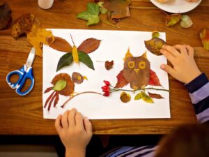 Child making art with leaves