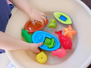 Child tests buoyancy of toys